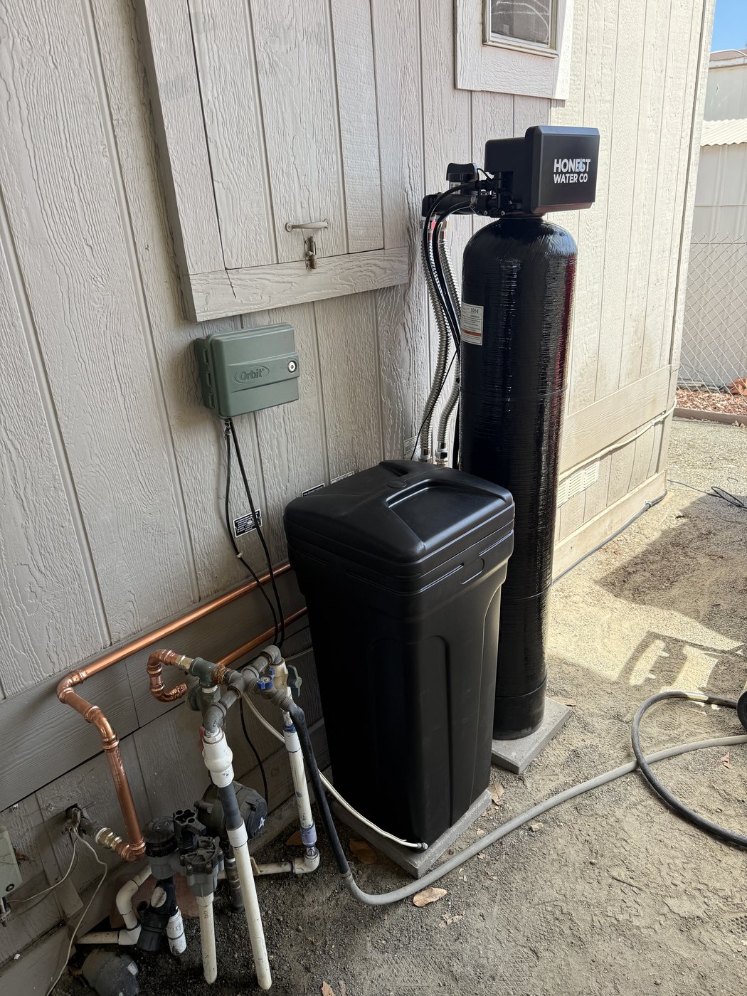 Honest Water Co side-yard water softener installation with copper manifold in Southern California